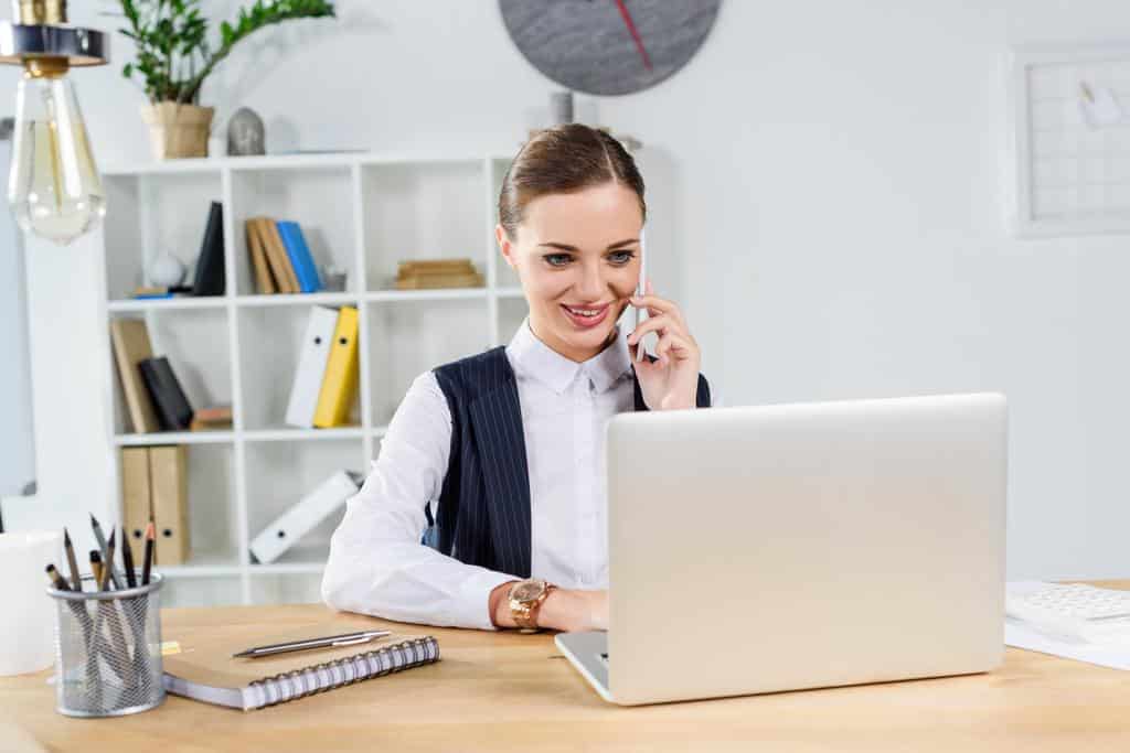 A young businesswoman taking a customer call while at the office.